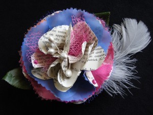 Embellished Book Flower Though not exactly glitzy, this book flower sports extra tulle, chiffon, satin, and a feather, courtesy of Toni G. Who could resist such a concoction?!!