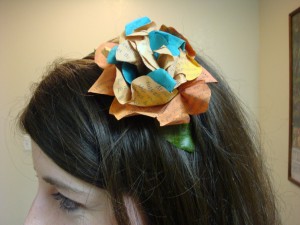 Book Flower Washed with simple acrylic paints, the text is still visible in this large book flower hotglued to a plastic headband.