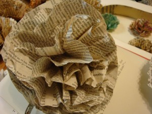 Making Book Flowers- Step 4? Unscrunch the layers to fluff the flower out. Apply a pin backing to the backside of the flower, or glue to whatever object you desire.
